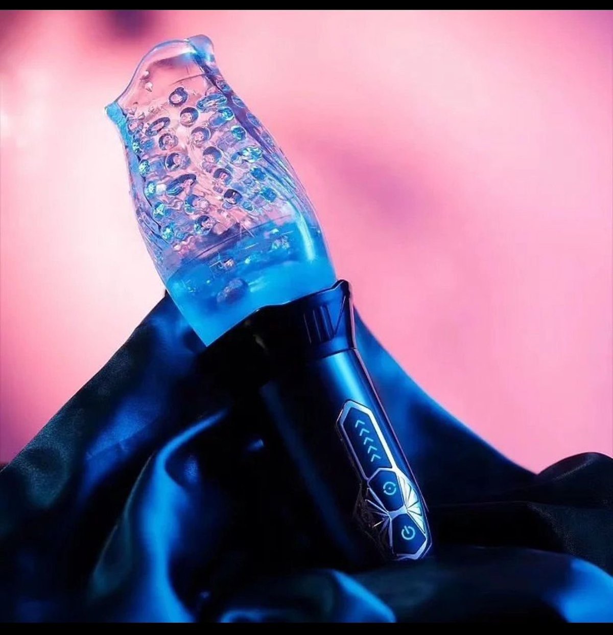 Hand in blue glove holding translucent blue bottle with bubbles against pink gradient background