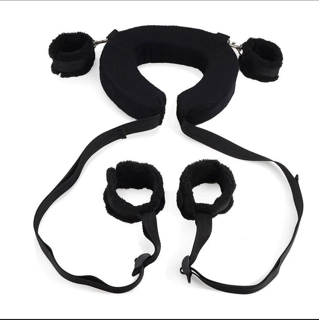 Black bed restraint set with padded cuffs for wrists and ankles on white background